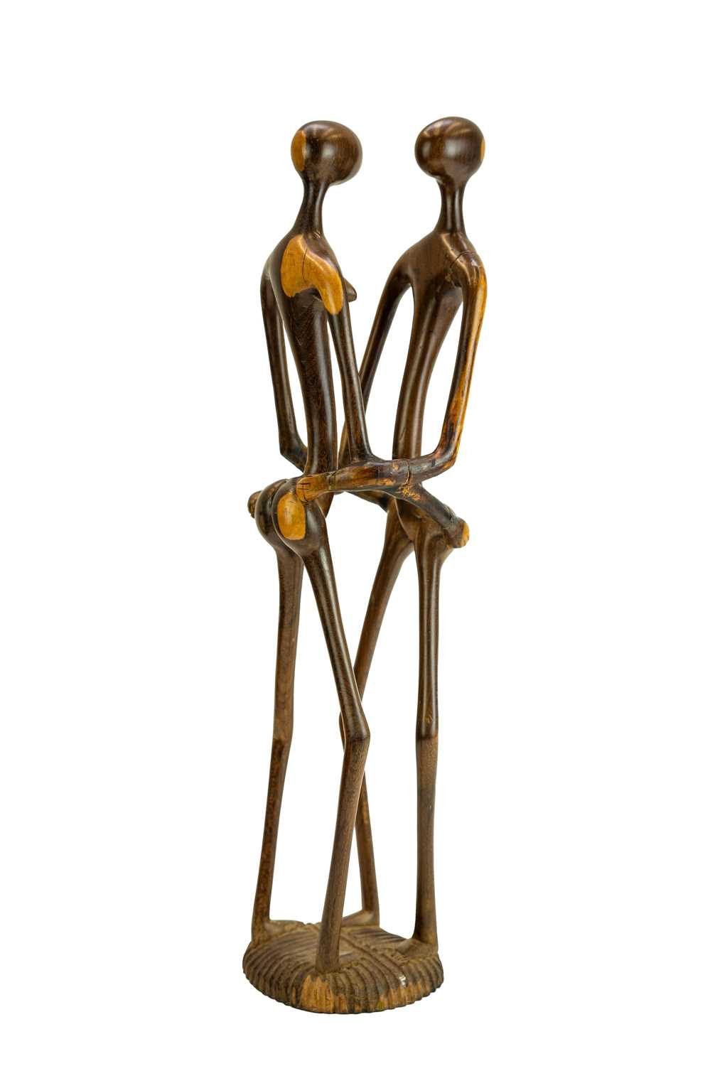 Lot 34 - An East African carved ebony or lignum vitae figure group.
