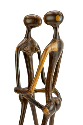 Lot 34 - An East African carved ebony or lignum vitae figure group.