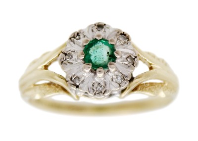 Lot 178 - An 18k gold emerald and diamond cluster ring.