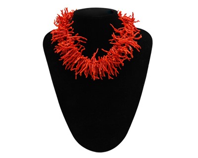 Lot 12 - A red coral necklace and matching bracelet, with a pair of clip-on earrings.