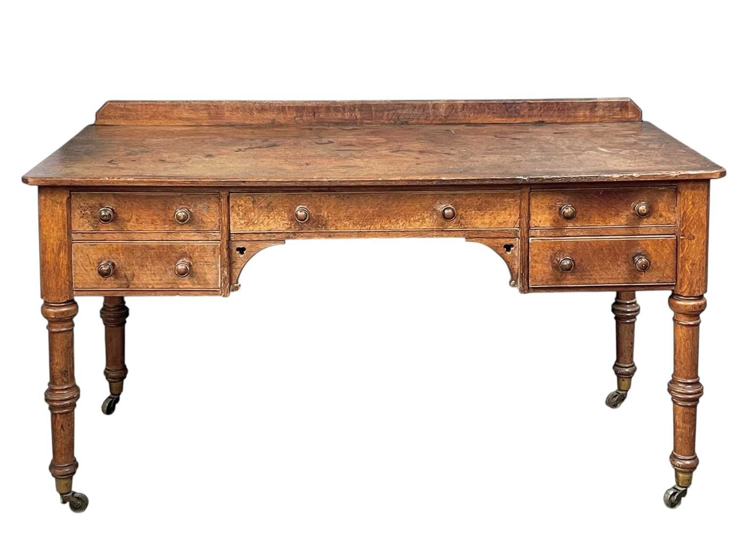 Lot 908 - A Holland & Sons oak writing or side table.