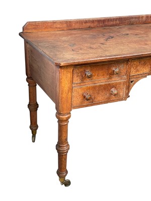Lot 908 - A Holland & Sons oak writing or side table.