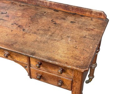 Lot 908 - A Holland & Sons oak writing or side table.