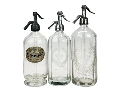 Lot 414 - Three glass soda syphons.
