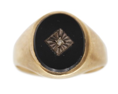 Lot 26 - A 9k gold, black onyx, and diamond signet ring, and a silver signet ring.