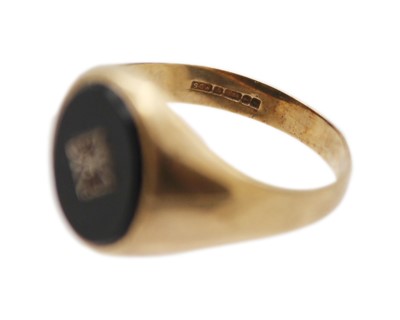 Lot 26 - A 9k gold, black onyx, and diamond signet ring, and a silver signet ring.
