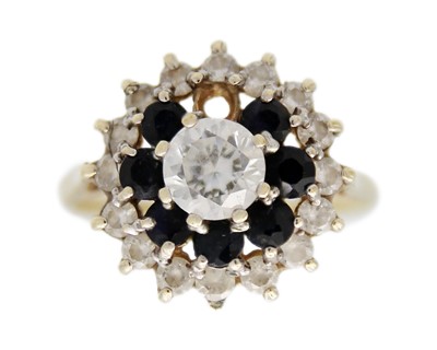 Lot 21 - A 9k gold CZ and sapphire cluster ring.