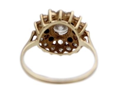 Lot 21 - A 9k gold CZ and sapphire cluster ring.