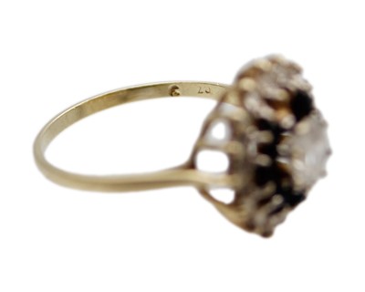 Lot 21 - A 9k gold CZ and sapphire cluster ring.