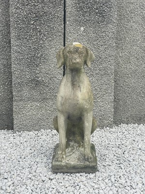 Lot 779 - A reconstituted stone sculpture of a seated dog.