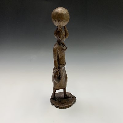 Lot 84 - A Nigerian bronze figure of a female water...