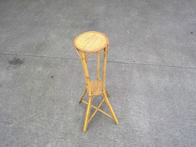 Lot 135 - A Cane Plant Stand. The Stand is 77cm tall and...