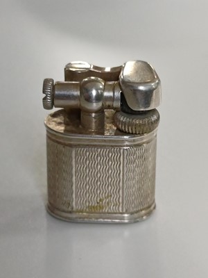 Lot 10 - DUNHILL - A 'Baby Sylph' silver-plated engine turned miniature lighter.
