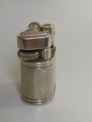 Lot 10 - DUNHILL - A 'Baby Sylph' silver-plated engine turned miniature lighter.
