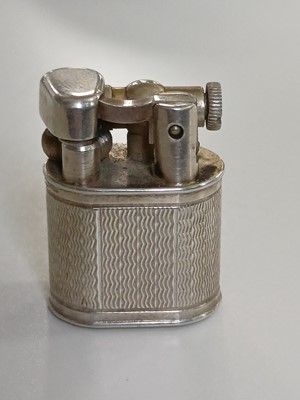 Lot 10 - DUNHILL - A 'Baby Sylph' silver-plated engine turned miniature lighter.