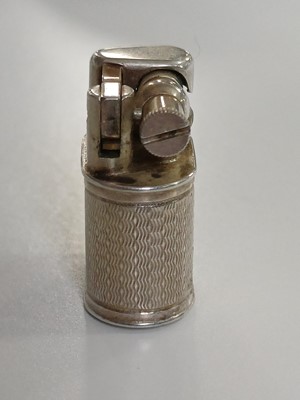 Lot 10 - DUNHILL - A 'Baby Sylph' silver-plated engine turned miniature lighter.