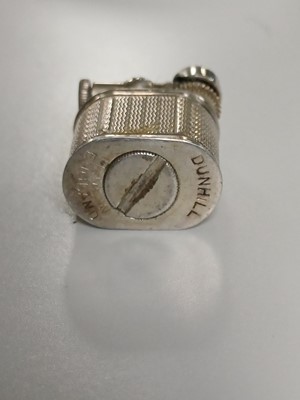 Lot 10 - DUNHILL - A 'Baby Sylph' silver-plated engine turned miniature lighter.