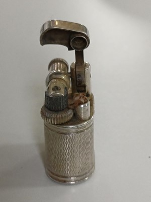 Lot 10 - DUNHILL - A 'Baby Sylph' silver-plated engine turned miniature lighter.
