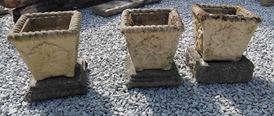 Lot 156 - Three stone effect planters with flowerhead...