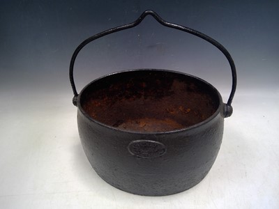 Lot 144 - A Cast Iron, Suspended Cooking Pot. The Pot is...
