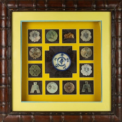 Lot 418 - A framed collection of archaic style Chinese jade plaques.