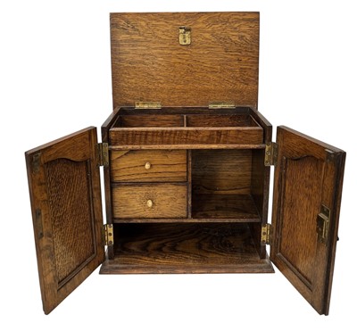 Lot 20 - An early 20th century English oak smoker's...