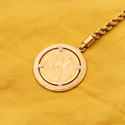 Lot 50 - A full sovereign framed in a high-purity gold key chain.