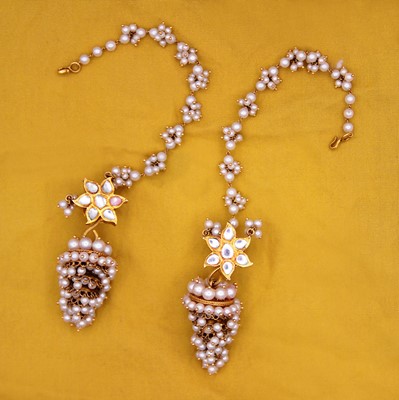 Lot 42 - A pair of traditional Indian 22k gold, pearl, and paste pendant earrings.