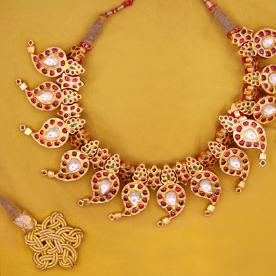 Lot 40 - A traditional Indian 22k gold, ruby, emerald, and white sapphire mango mala necklace.
