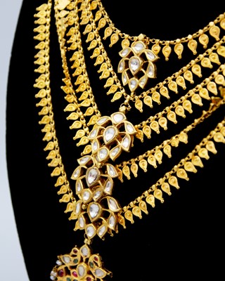 Lot 33 - A traditional Indian 22k gold rani haar five-row fringe necklace with gemstones.