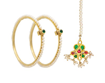 Lot 102 - Two traditional Indian silver gilt bangles with pearls, and a silver gilt with paste pendant.