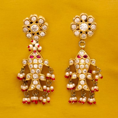 Lot 43 - A pair of traditional Indian 22k gold, white sapphire, ruby, and pearl Matsya pendant earrings.