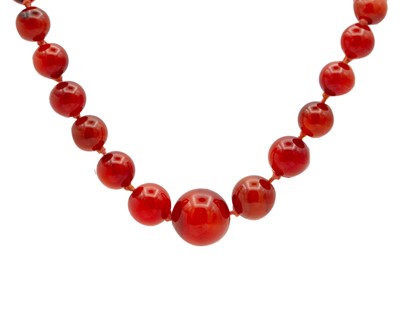 Lot 111 - A carnelian bead necklace with a rose gold ring bolt clasp.