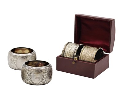 Lot 122 - A cased pair of Victorian silver napkin rings, and one other pair of silver napkin rings.