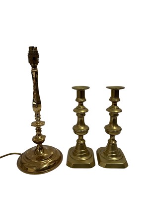 Lot 167 - A pair of brass candlesticks and a brass lamp,...
