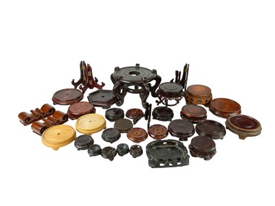 Lot 435 - A collection of Chinese hardwood stands and plate stands.