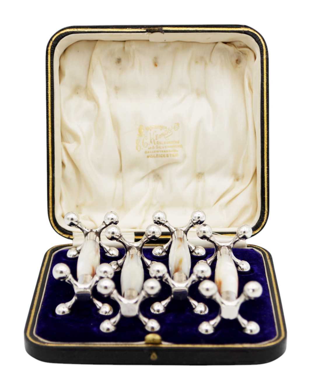 Lot 261 - An Edwardian boxed set of quality silver mounted mother of pearl knife rests.