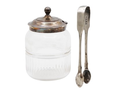 Lot 116 - A George V silver lidded cut glass condiment jar, and a George IV silver pair of tongs.