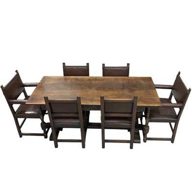 Lot 4 - A carved, dark oak refectory dining table with...