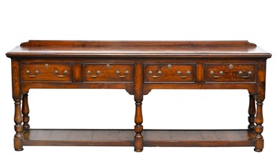 Lot 890 - A George III style oak low dresser.