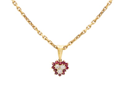 Lot 53 - A high-purity gold chain with a ruby and diamond trefoil cluster pendant.