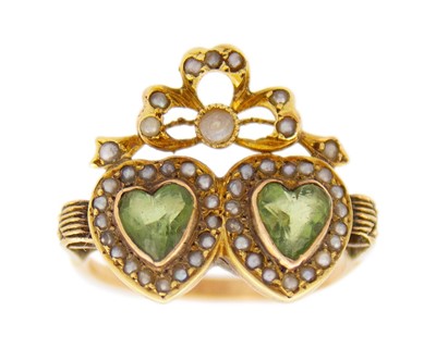 Lot 8 - An Edwardian peridot and half-seed pearl twin heart gold ring.