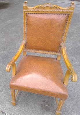 Lot 35 - A carved wood chair with a leather seat and back.