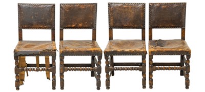 Lot 914 - A set of four Cromwellian style oak and leather upholstered dining chairs.