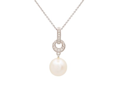 Lot 103 - A 9k white gold, white pearl, and diamond pendant necklace.