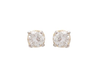 Lot 106 - A pair of 18k gold diamond solitaire stud earrings.