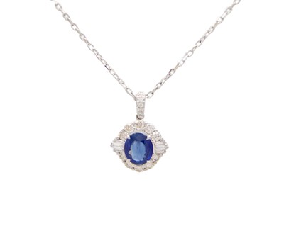 Lot 115 - An 18k white gold, sapphire, and diamond cluster pendant necklace.