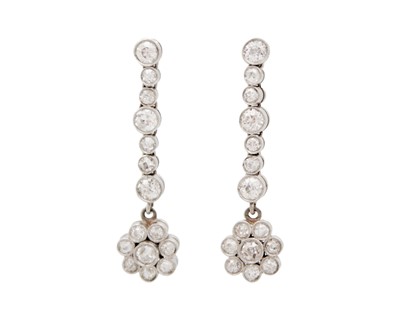 Lot 134 - A pair of diamond daisy cluster drop earrings.