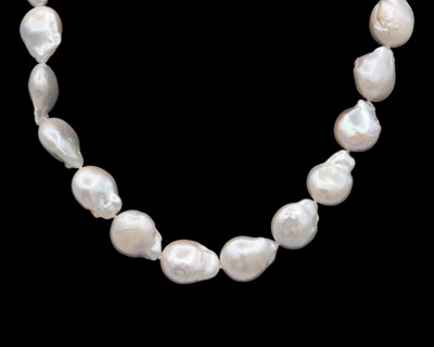 Lot 146 - A cultured baroque pearl necklace with a brushed gold-plated and silver hinged hoop clasp.