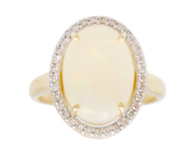 Lot 154 - A 14k gold opal and diamond halo dress ring.